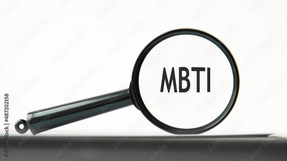 look closely and MBTI with a magnifying glass. business concept. magnifying glass on the gray background look closely and MBTI with a magnifying glass. business concept. magnifying glass on the gray background