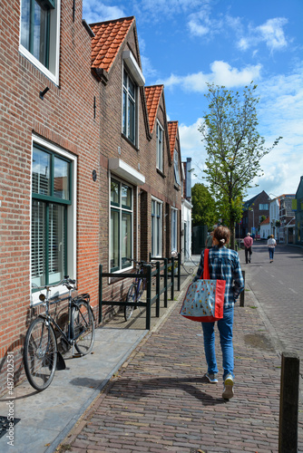Wallpaper Mural Typical Dutch street - bicycles , house facade and people on a street Torontodigital.ca