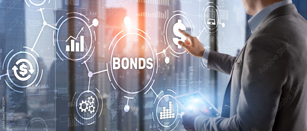 © Funtap - Businessman clicks a bonds virtual screen. Bond Finance Banking Technology concept. Trade Market Network