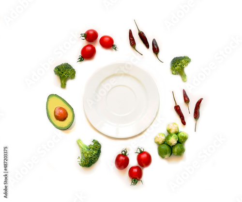 Fototapeta Naklejka Na Ścianę i Meble -  Ingredients for proper nutrition and empty plate on white background. The concept of healthy diet. Close-up