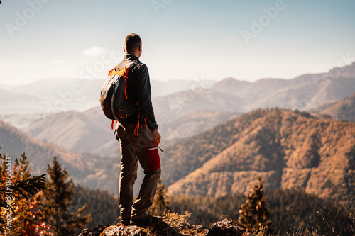  Young traveler hiking girl with backpacks. Hiking in mountains. Sunny landscape. Tourist traveler on background view mockup. High tatras , slovakia photo