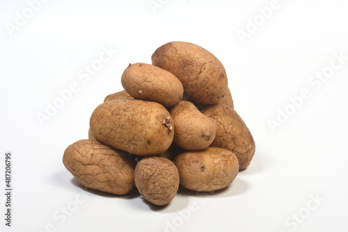 heap of old potatoes isolated on white background photo