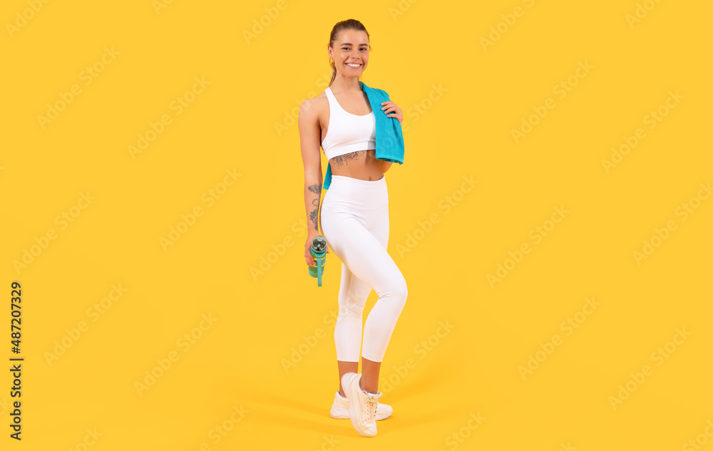 sport woman with water bottle on yellow background
