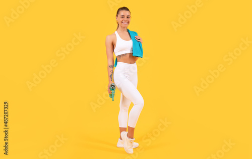 sport woman with water bottle on yellow background