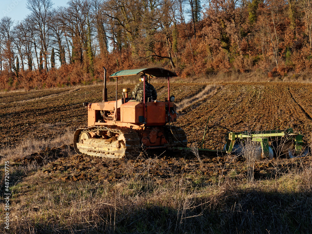 Agriculture,tractor preparing land with seedbed cultivator as part of pre seeding activities in early spring season of agricultural works at farmlands.