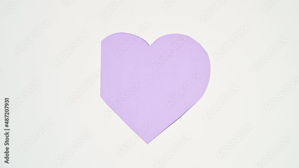 Creative Heart white frame filling with bright purple color. Stop motion valentine flat lay concept Creative Heart white frame filling with bright purple color. Stop motion valentine flat lay concept