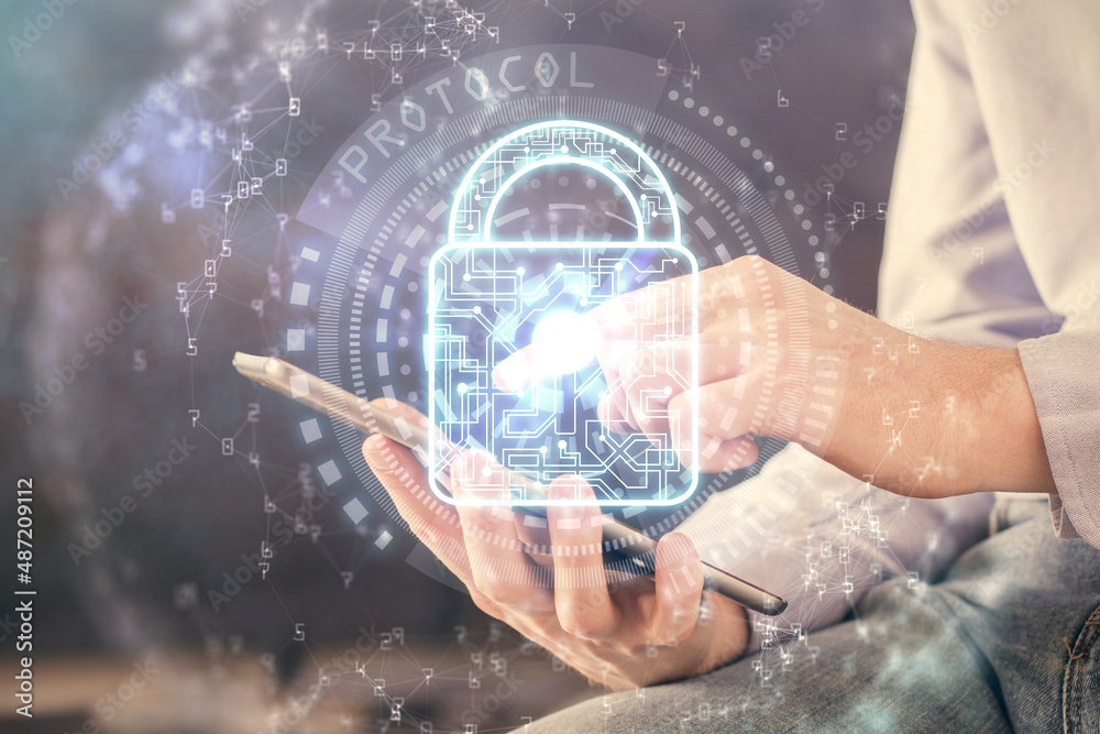 Multi exposure of man's hands holding and using a digital device and lock drawing. Security concept. Multi exposure of man's hands holding and using a digital device and lock drawing. Security concept.