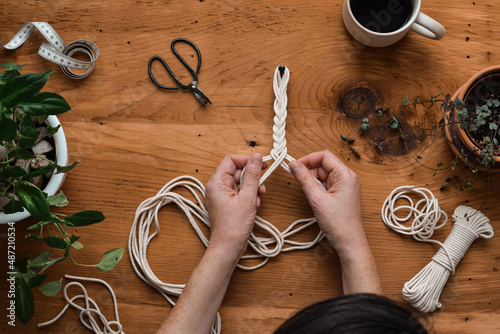 Fotografie Top down view of woman making macrame plant hanger