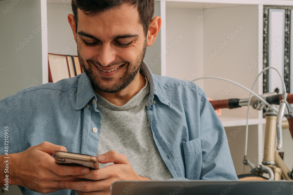 man working at home with computer and using mobile phone man working at home with computer and using mobile phone