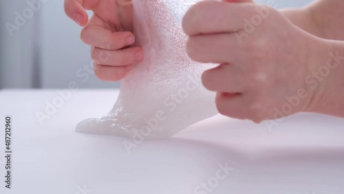 Children's hands close-up. The child plays with a sticky toy. Stress relief. Nice toy. Relaxation and recovery.
