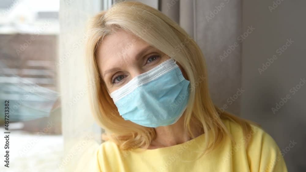 Portrait of mature caucasian female office worker wearing face mask, looking at camera, headshot of woman at the home, protection prevention, and social distancing concept Portrait of mature caucasian female office worker wearing face mask, looking at camera, headshot of woman at the home, protection prevention, and social distancing concept