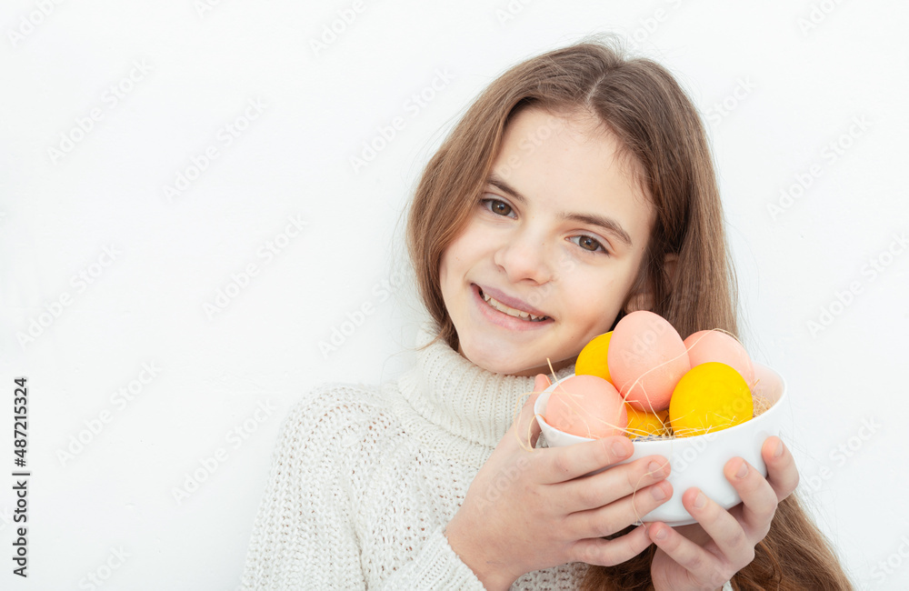 Young girl holds bowl with colorful eggs white background right Young girl holds bowl with colorful eggs white background right