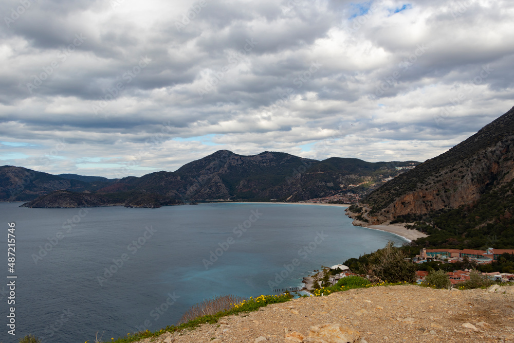 Oludeniz beach view from  top of the mountaints. Green and blue sea seems. Clouds,mountains and beaches. 