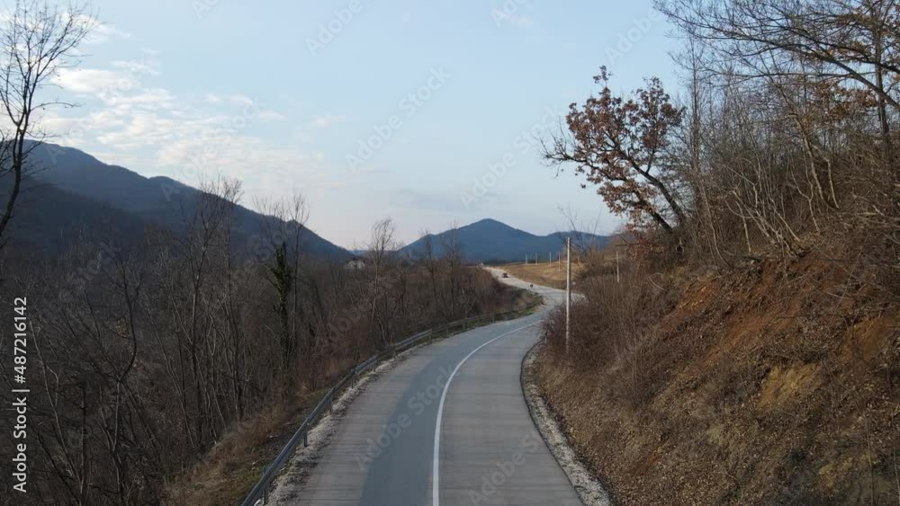 Travel journey transport and vacation concept High angle aerial view drone video on the road following car driving in autumn or winter day near Knjazevac in Serbia Travel journey transport and vacation concept High angle aerial view drone video on the road following car driving in autumn or winter day near Knjazevac in Serbia