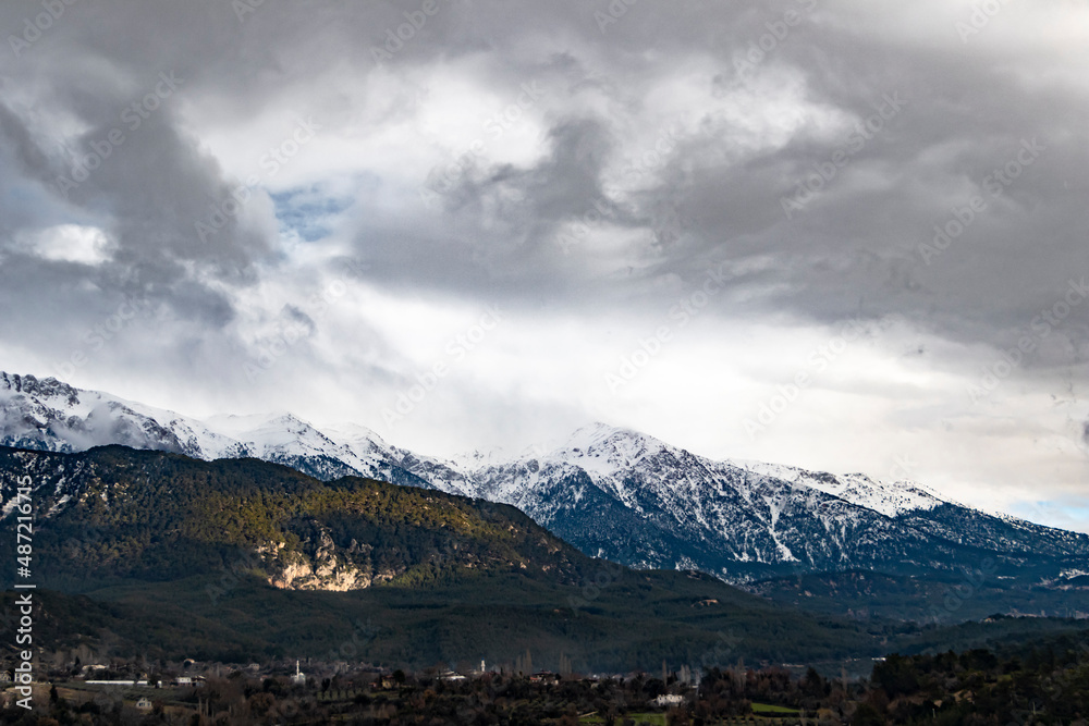 Foggy snowy mountains. Magical atmosphere of a foggy morning in a mountain. Copy paste banner space.	