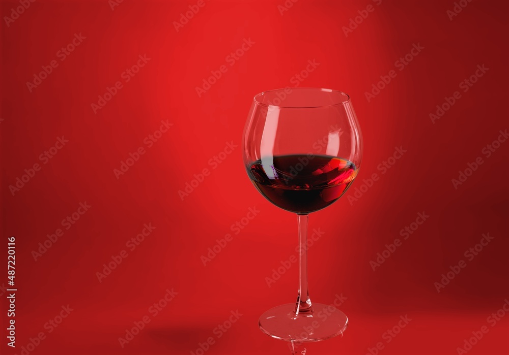 Red wine glass over colored background on the desk Red wine glass over colored background on the desk