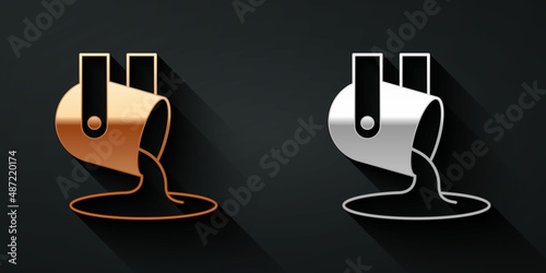 Gold and silver Molten gold being poured icon isolated on black background. Molten metal poured from ladle. Long shadow style. Vector