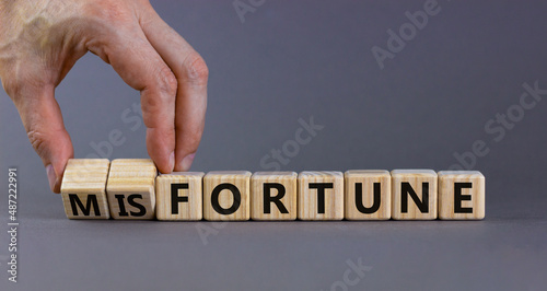 Wallpaper Mural Fortune or misfortune symbol. Businessman turns wooden cubes and changes the concept word misfortune to fortune. Beautiful grey background, copy space. Business, fortune or misfortune concept. Torontodigital.ca
