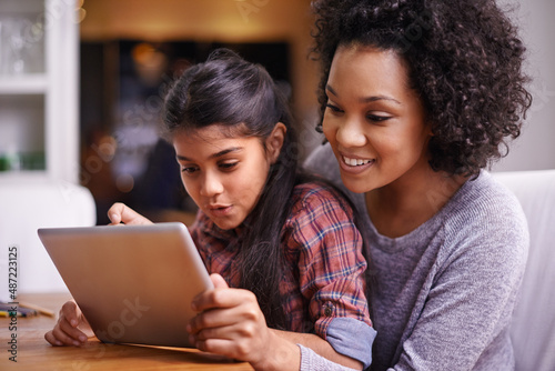 Everyday you learn something new. Shot of a mother and daughter using a digital tablet together.