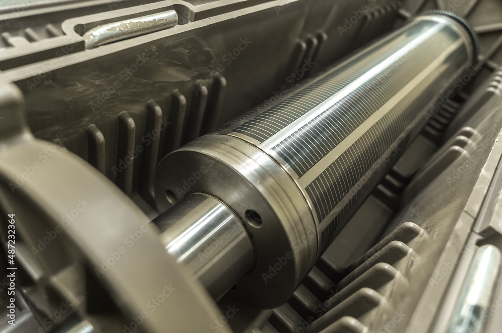 Used magnetic cylinder for rotary printing machine in plastic box. Magnetic shaft for die mounting. Selective focus Used magnetic cylinder for rotary printing machine in plastic box. Magnetic shaft for die mounting. Selective focus