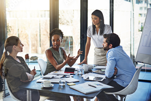 Putting their heads together as a team. Shot of a group of businesspeople having a meeting in a boardroom.
