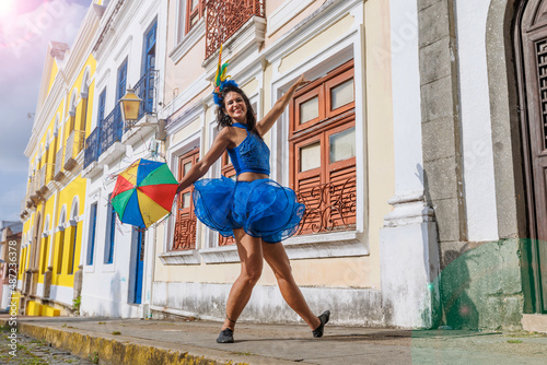 Beautiful Latin dancer dressed up for Carnival on the streets of Olinda. Frevo Recife. Brazil colors. Historical city. photo