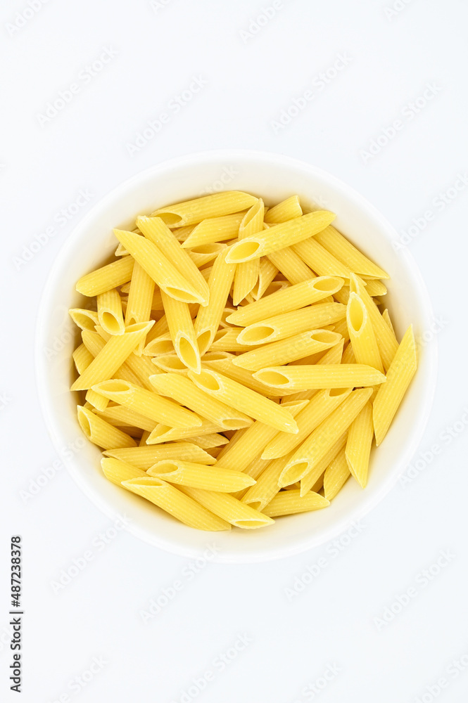 Raw penne rigate pasta, in a white bowl, isolated on a white background
Raw penne rigate pasta, in a white bowl, isolated on a white background