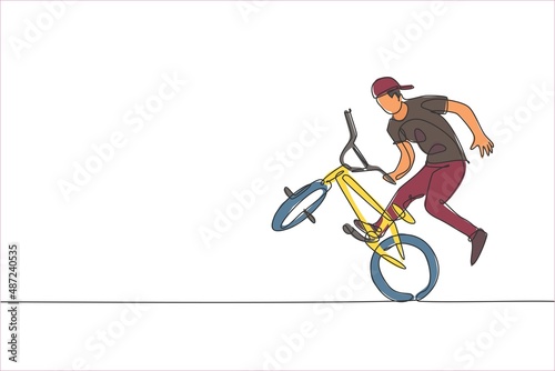 One single line drawing of young bmx bicycle rider performing freestyle trick on street vector illustration. Extreme sport concept. Modern continuous line draw design for freestyle competition banner photo