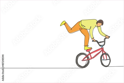 One single line drawing of young bmx bicycle rider performing freestyle trick on street vector illustration. Extreme sport concept. Modern continuous line draw design for freestyle competition banner