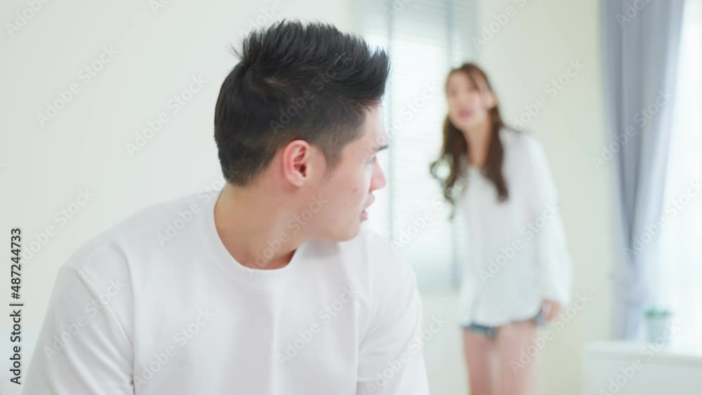 Asian young couple sitting on bed with painful after fight argument. Asian young couple sitting on bed with painful after fight argument.