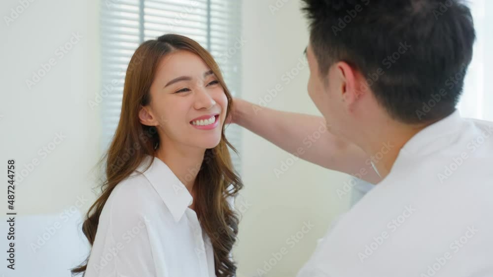 Portrait of Asian new marriage couple sit on bed and look each other.
Portrait of Asian new marriage couple sit on bed and look each other.