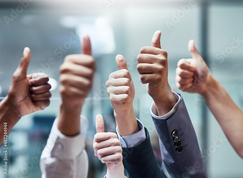 Good job. Shot of a group of hands showing thumbs up.
