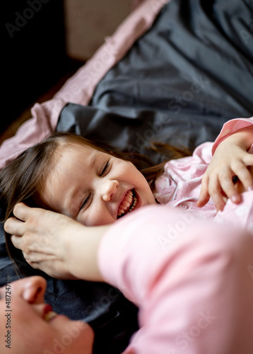 Happy loving family. Mother and her daughter are playing at home.