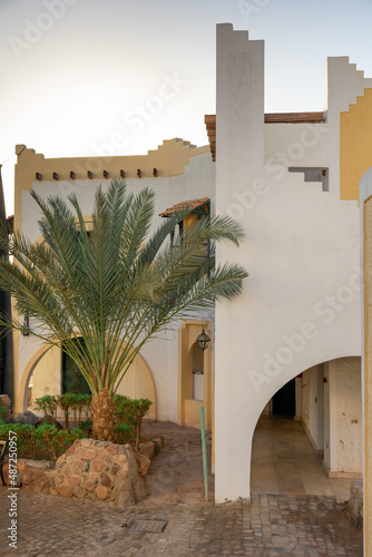 Exterior of house in oriental style. Architecture traditional old yellow Arabic house with arches and stairs in minimalist style, Sharm El Sheikh, Egypt. High quality photo