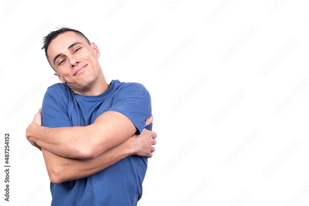 Man hugging himself with a happy expression Man hugging himself with a happy expression