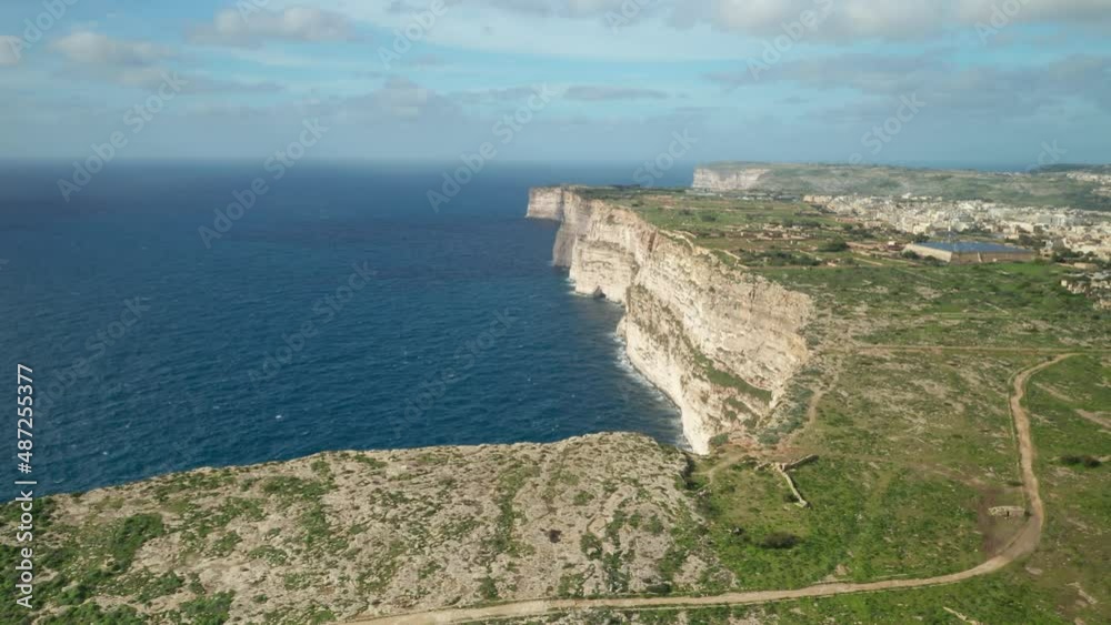 AERIAL: Beautiful Ta Cenc Cliffs Being Washed by Blue Mediterranean Sea on Windy Day AERIAL: Beautiful Ta Cenc Cliffs Being Washed by Blue Mediterranean Sea on Windy Day