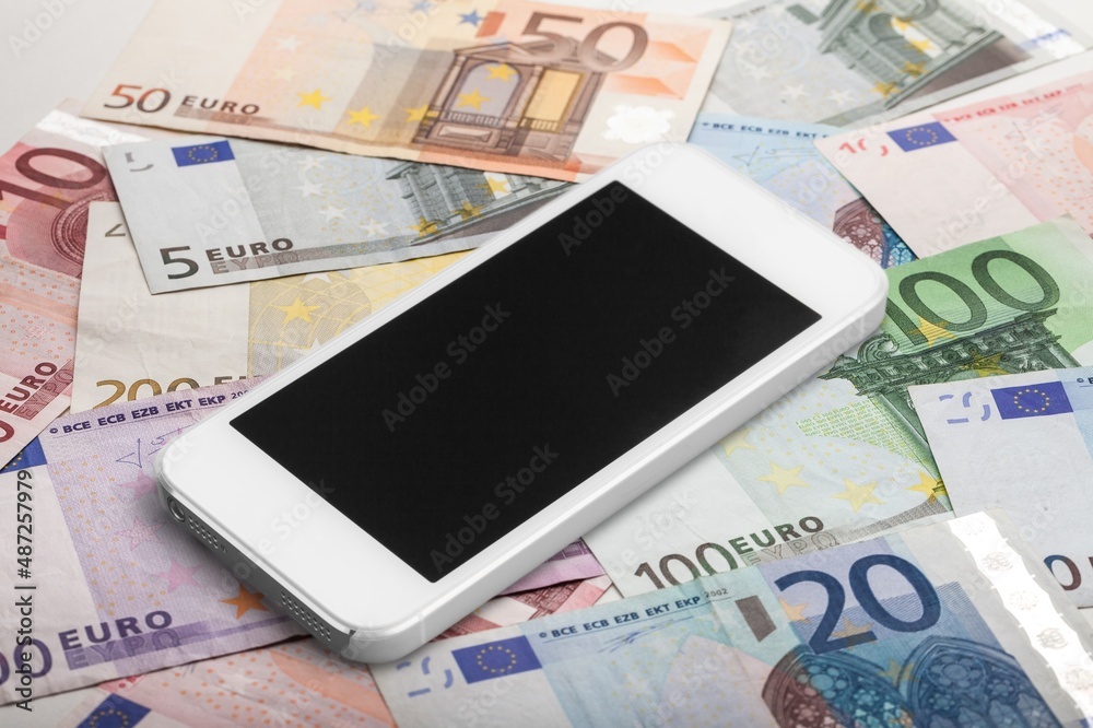 Blank screen smartphone on the pile of money Blank screen smartphone on the pile of money
