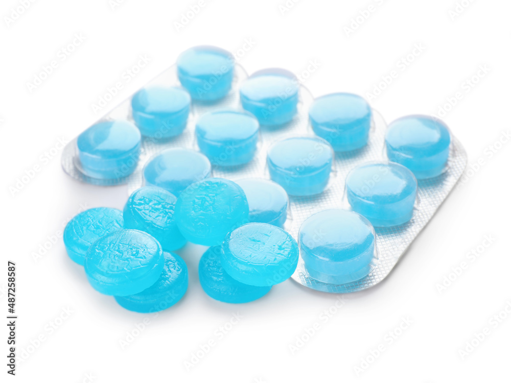 Many light blue cough drops on white background Many light blue cough drops on white background