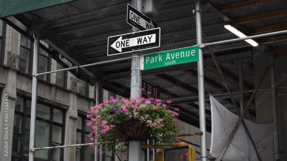 One-way crosswalk sign at Park Avenue South, NYC on a rainy day