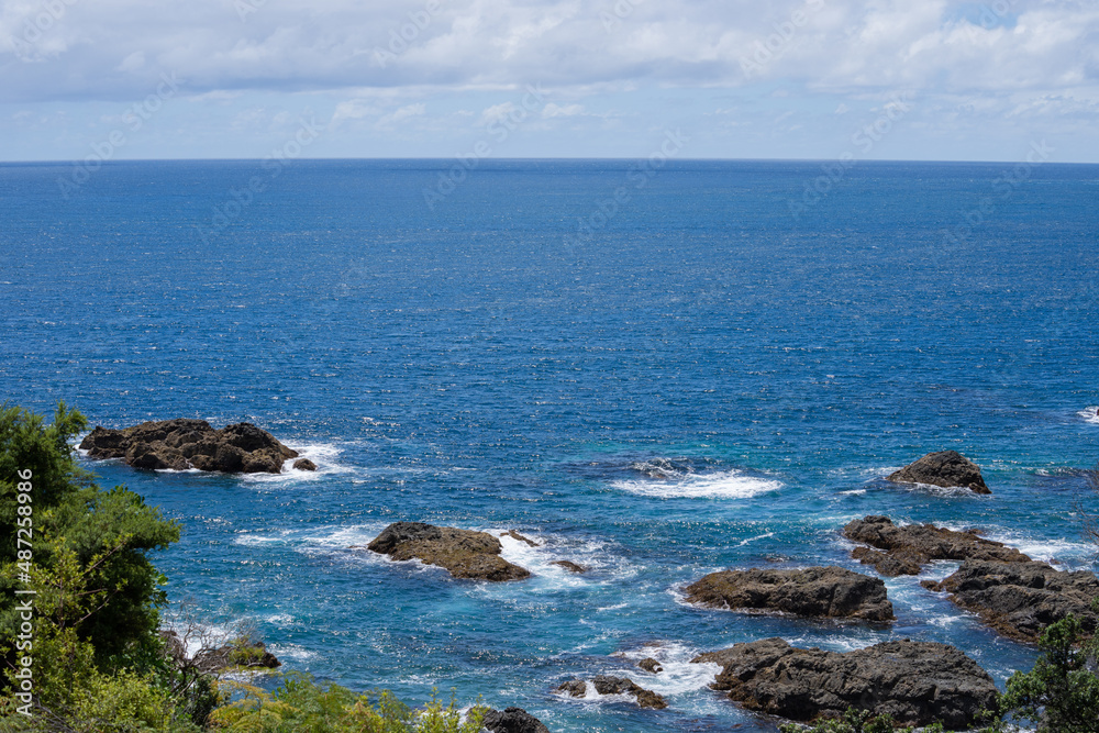 Rugged rocky coastline and view to horizon on east coast of Bay Of Plenty, New Zealand at Te Kaha.