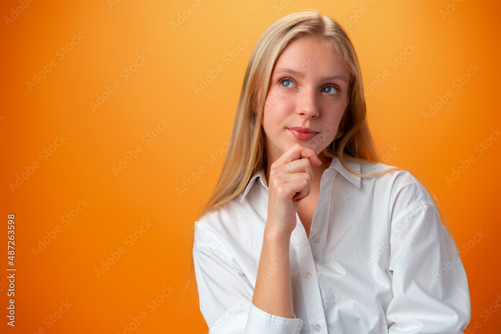 Portrait of cute thoughtful teen girl against orange background Portrait of cute thoughtful teen girl against orange background