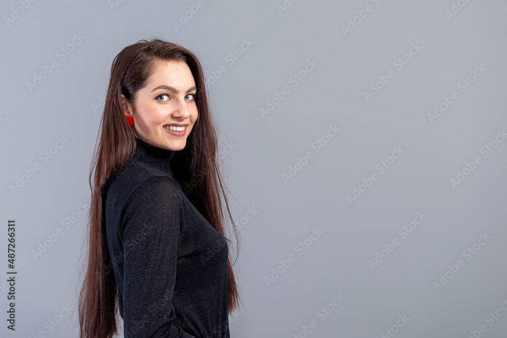 portrait of young sensual woman with long hair against gray background with copy space portrait of young sensual woman with long hair against gray background with copy space