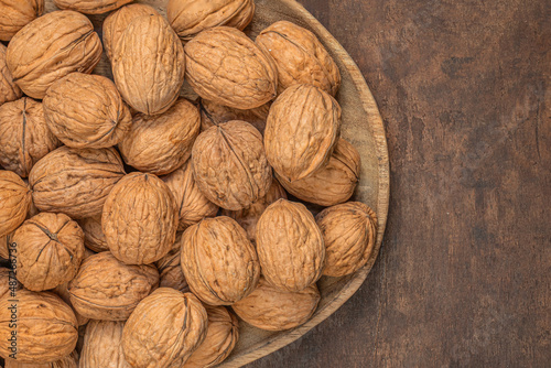 Walnuts on dark vintage table. Walnuts kernels top view, copy space.