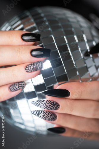 Woman hands with beautiful black manicure