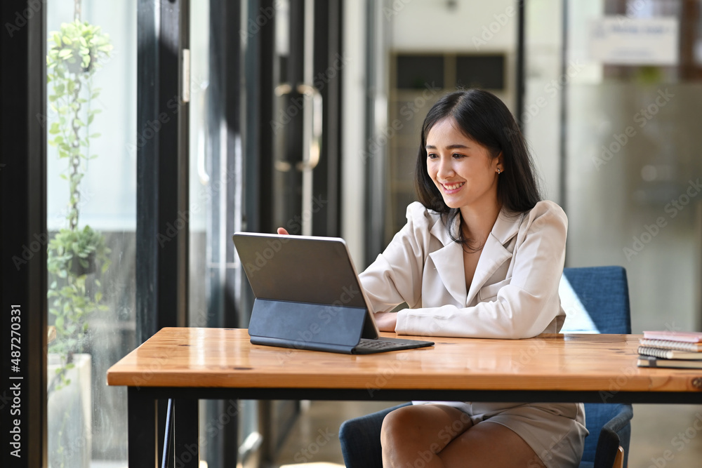 Happy asian businesswoman reading good news on computer tablet. Happy asian businesswoman reading good news on computer tablet.