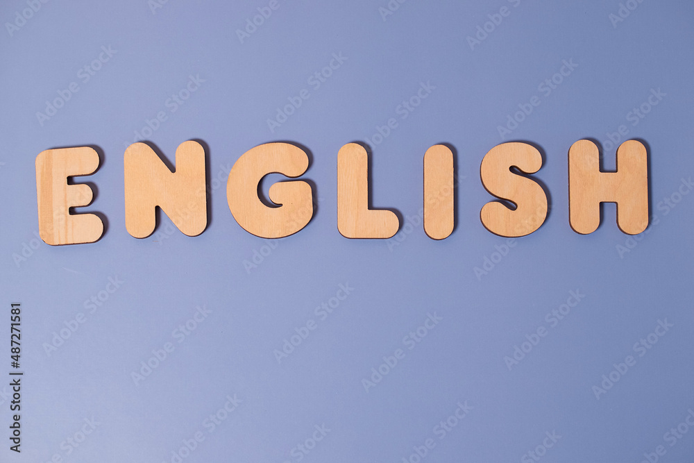 The word English made of wooden letters on a colored background The word English made of wooden letters on a colored background