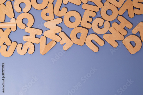 A set of wooden letters of the English alphabet on a colored background