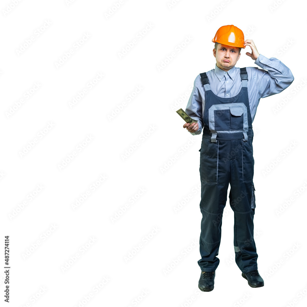 The repair technician does not understand what happened. the man scratches his head with a hand in a helmet and shows us a bill. isolated The repair technician does not understand what happened. the man scratches his head with a hand in a helmet and shows us a bill. isolated