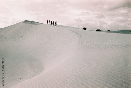 Black and white landscape photo film: girls in Nam Cuong sand dunes. Time: Saturday afternoon, February 5, 2022. Location: Ninh Thuan province. photo