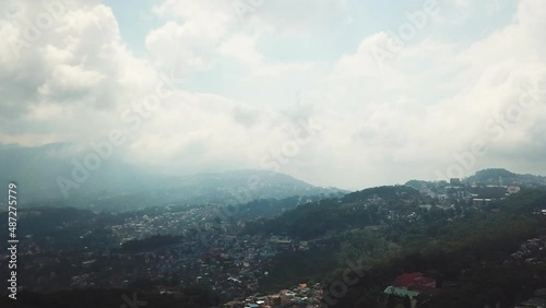 Dolly Out Aerial Shot Of A Cloudy Baguio City, With Lots Of Houses photo